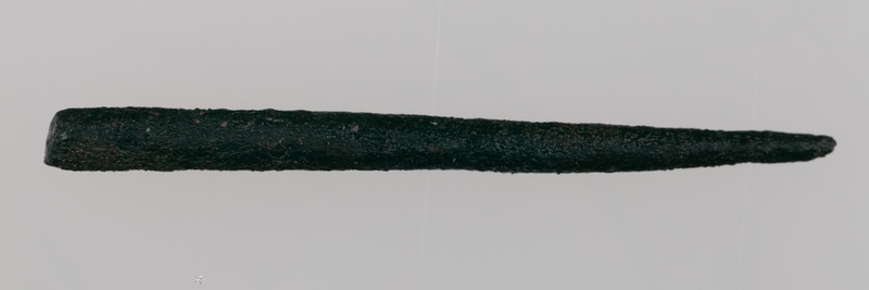 Fragmenty ozdób wykonanych z brązu, przepalonych na stosie, w tym skręt i szpila