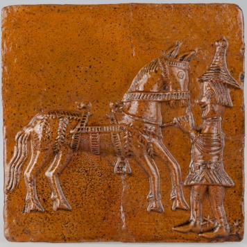 Kafel z giermkiem trzymającym konia